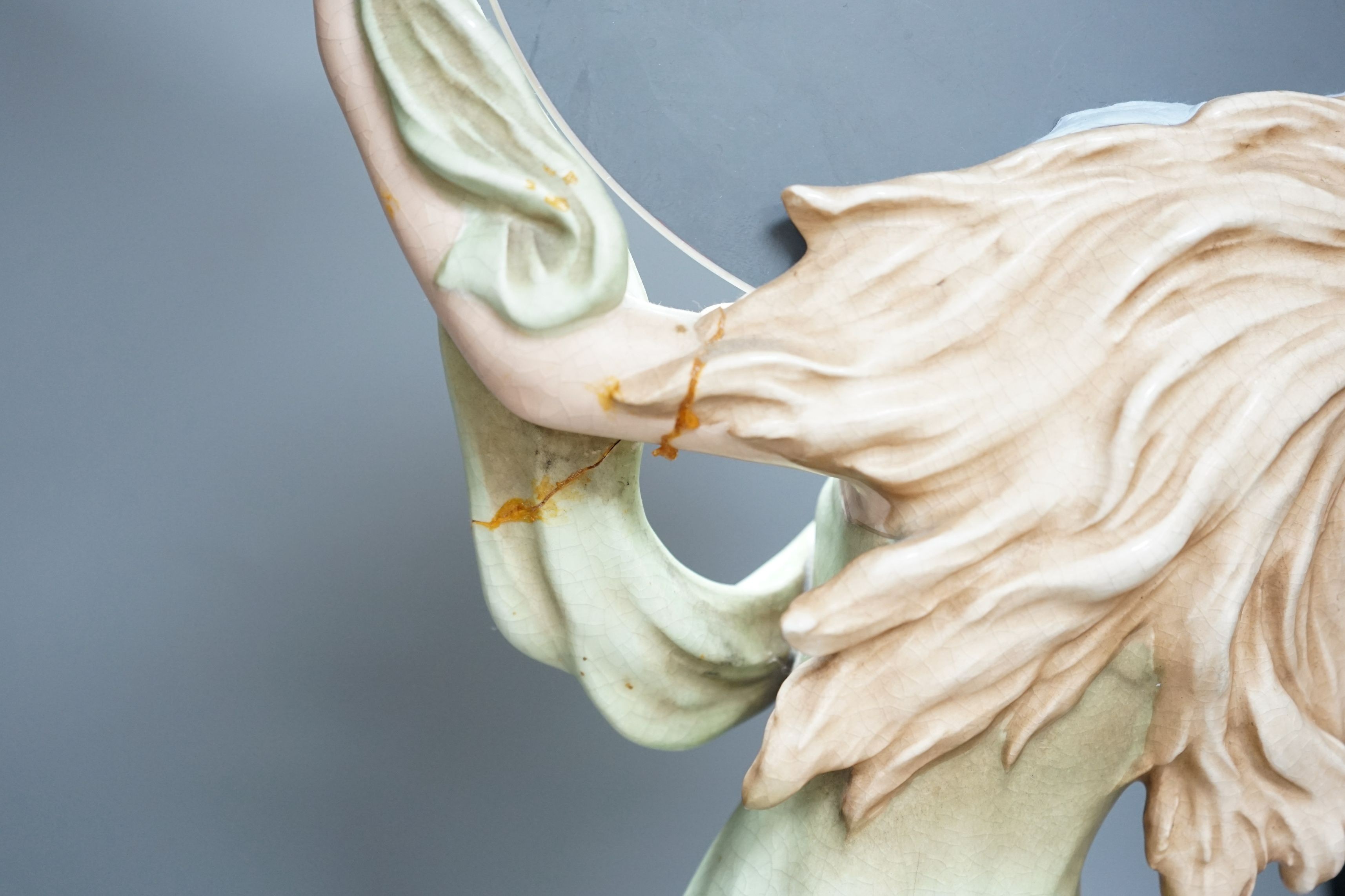A continental Art Nouveau ceramic figure of a lady holding a mirror, 57cms high not including mirror